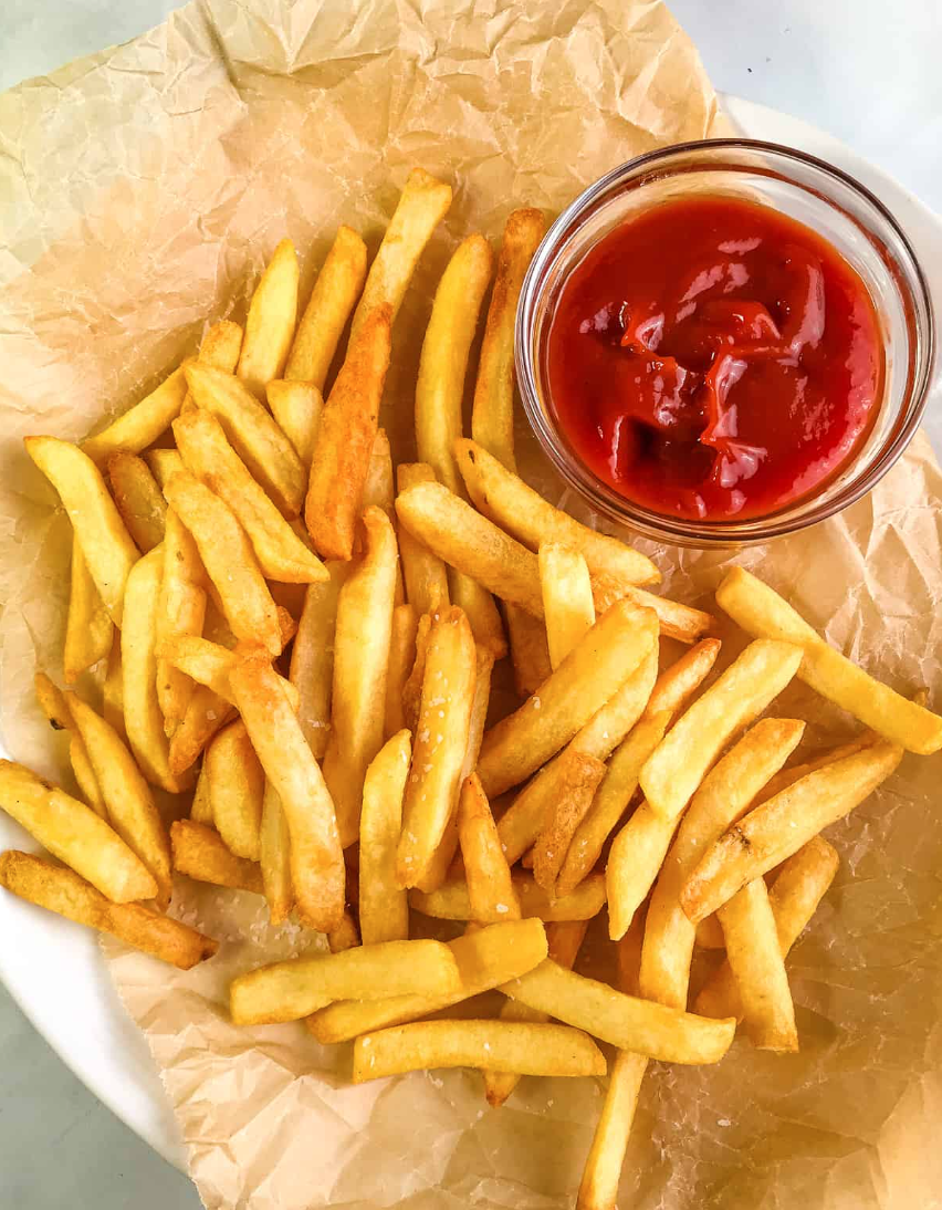 Fries and tomato sauce on a platter